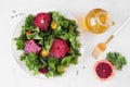 Healthy salad with kale and red blood oranges. Above view scene on white marble. Royalty Free Stock Photo