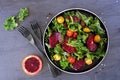 Healthy salad with kale and red blood oranges over a dark slate background Royalty Free Stock Photo