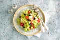 Healthy salad of lettuce, tomato, red pepper, soft cheese, olives, avocado, onion with olive oil and lemon juice. Royalty Free Stock Photo