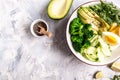 Healthy salad meal with egg, avocado and mixed fresh vegetables on a light background, Healthy meal concept, top view Royalty Free Stock Photo