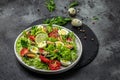 Healthy salad with mussels, quail, egg, conjugate, lime, spinach, lettuce, cherry tomatoes and microgreen. Keto lunch diet