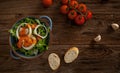 Healthy salad plate with a bread on a dark wooden table Royalty Free Stock Photo