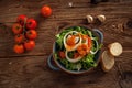 Healthy salad plate with a bread on a dark wooden table Royalty Free Stock Photo