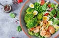 Healthy salad plate. Fresh seafood recipe. Grilled shrimps and fresh vegetable salad, egg and broccoli. Grilled prawns. Royalty Free Stock Photo