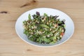 Healthy salad plate of quinoa and lettuce on a wood table Royalty Free Stock Photo