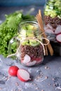 Healthy salad with quinoa, avocado, cucumber and radish with lettuce leaf and olive oil.