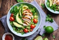 Healthy salad with quinoa, cherry tomatoes, chicken meat, avocado, lime and mixed greens, lettuce, parsley on a wooden table. Royalty Free Stock Photo