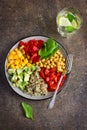 Healthy salad with quinoa, chickpeas, avocado, bell pepper, spin