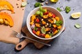 Healthy salad with roasted squash, chickpeas and black lentils, autumn food, vegan eating