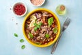 Healthy salad with tuna, white beans, cherry tomatoes, red onion and basil leaves in ceramic bowl on concrete background Royalty Free Stock Photo