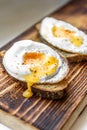 Healthy sandwich of fried egg with rye bread on wooden cutting board on white background Royalty Free Stock Photo