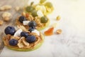 Health and Dieting Food. Green apple slices with peanut butter and blueberries on rustic table Health and Dietting