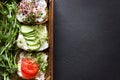 Healthy sandwiches with cream cheese , microgreens, tomatoes and cucumber in  wooden box. Healthy eating, diet food, vegan food, Royalty Free Stock Photo