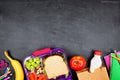 Healthy school lunch box and school supplies bottom border on a chalkboard background Royalty Free Stock Photo