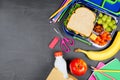 Healthy school lunch box and school supplies side border on a chalkboard background Royalty Free Stock Photo