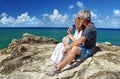 Healthy senior couple resting after hiking to cliff top tropical island