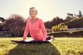 Healthy senior woman in a yoga pose with gentle sunflare