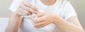 Healthy skin care, hand of of asian young woman squeeze out cream from tube on her back hand before applying moisturizer, putting Royalty Free Stock Photo