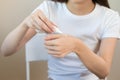 Healthy skin care, hand of of asian young woman squeeze out cream from tube on her back hand before applying moisturizer, putting Royalty Free Stock Photo