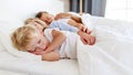 Healthy sleep. happy family parents and children sleeping in white bed Royalty Free Stock Photo