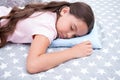 Healthy sleep tips. Girl sleeps on little pillow bedclothes background. Girl child long hair fall asleep pillow close up