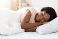 Smiling pretty black woman sleeping in her bed at home Royalty Free Stock Photo