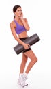 Healthy smiling brunette holding yoga mat Royalty Free Stock Photo