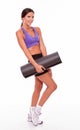 Healthy smiling brunette holding yoga mat Royalty Free Stock Photo
