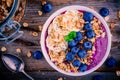 Healthy smoothie bowl with granola, banana and fresh blueberries