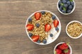 Healthy smoothie bowl with granola, yogurt, strawberry and fresh blueberries on wooden background. Breakfast smoothie bowl Royalty Free Stock Photo