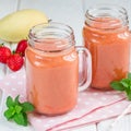 Healthy smoothie with strawberry, mango and banana in glass jars, square format Royalty Free Stock Photo