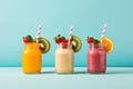 Healthy smoothies with kiwi, orange and strawberry in glass jars on blue background, Fresh fruit smoothies in glass jars with Royalty Free Stock Photo