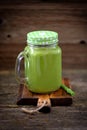 Healthy smoothies in mason jar from spinach, cucumber, celery, apple, parsley with olive oil, Himalayan rose salt and mineral wate Royalty Free Stock Photo