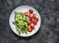 Healthy snack, breakfast - sandwich with avocado and fresh strawberries on a dark background, top view Royalty Free Stock Photo