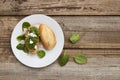 Healthy snack. Bun or bread with pesto pasta and basil leaves. Rustic wooden table, top view. Royalty Free Stock Photo