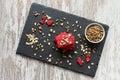 Healthy snack cracker or biscuit with seeds and beetroot top view on a stone plate with oat flakes on wooden background Royalty Free Stock Photo