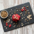 Healthy snack cracker or biscuit with seeds and beetroot top view on a stone plate with oat flakes on wooden background, healthy Royalty Free Stock Photo