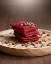 Healthy snack cracker or biscuit with seeds and beetroot top view on a stone plate with oat flakes on wooden background, idea Royalty Free Stock Photo