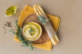 Healthy snack from crispbread with hummus, olive oil and rosemary on light background