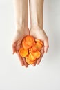 Healthy snack of dry carrot in hands isolated on white background, healthy food and lifestyle,100 calories portion