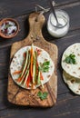 Healthy snack - fresh zucchini, carrots, sweet red pepper, natural yogurt, and a homemade tortilla