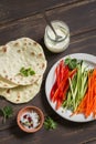 Healthy snack - fresh zucchini, carrots, sweet red pepper, natural yogurt, and a homemade tortilla