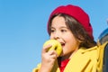 Healthy snack for a kid. Cute child eating healthy fruit on sunny day. Little girl biting into juicy green apple for Royalty Free Stock Photo