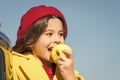 Healthy snack for a kid. Cute child eating healthy fruit on sunny day. Little girl biting into juicy green apple for Royalty Free Stock Photo