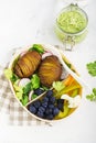 Healthy snack in a lunch box: Golden baked potatoes, salad, blueberries, green pepper, cauliflower, radish in a plastic Royalty Free Stock Photo