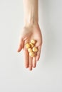Healthy snack of macadamia in hand isolated on white background, healthy food and lifestyle,100 calories portion