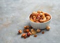 Healthy snack: a mixture of dried fruits and different types of nuts on a gray background. Royalty Free Stock Photo