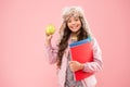 Healthy snack. Modern education. Stylish schoolgirl. Girl little smiling schoolgirl hold apple fruit. Schoolgirl happy