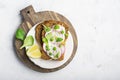 Healthy snack: slice grain bread with ricotta, green peas, radishes, lemon zest and juice. Top view