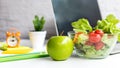 Healthy snack with working in office. Green apple and fresh salad with water for diet Health Plan with laptop Royalty Free Stock Photo